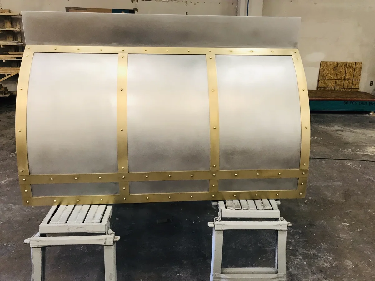 Custom cast pewter and brass range hood by La Bastille