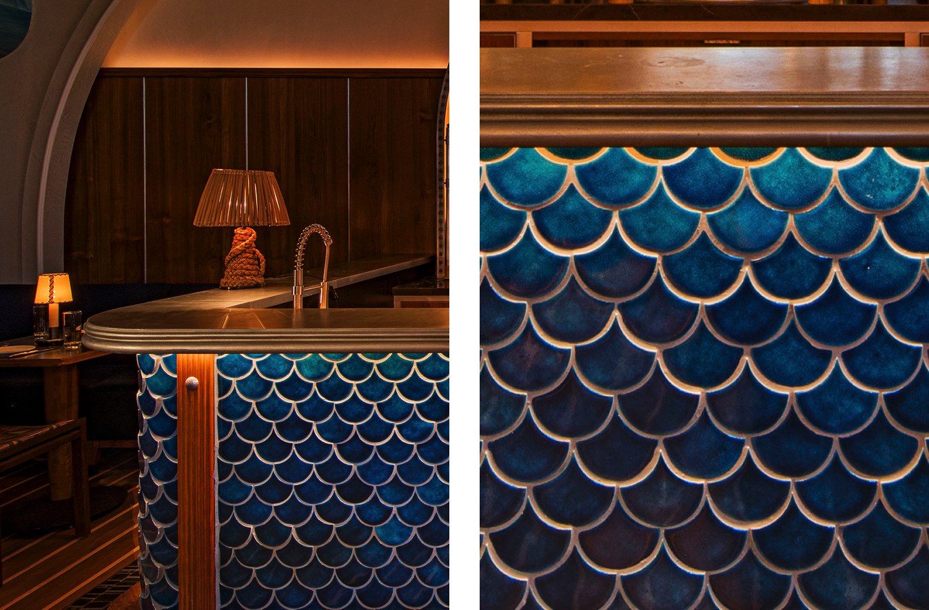 zinc bar top with blue scalloped tile in an oyster bar and seafood restaurant 